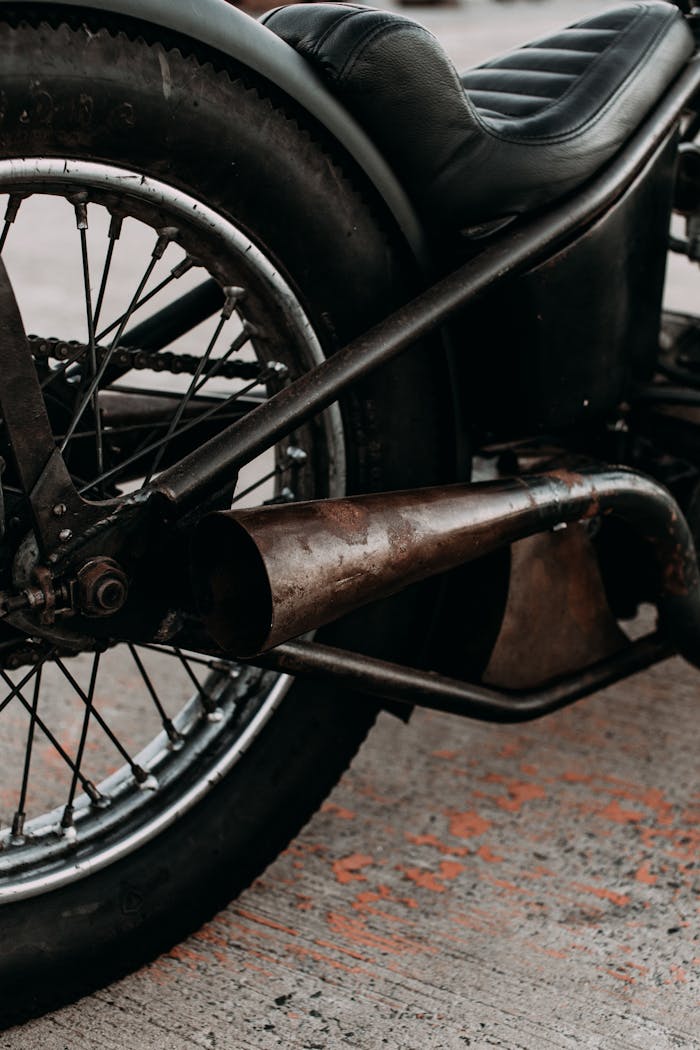 Motorbike with leather saddle and exhaust pipe